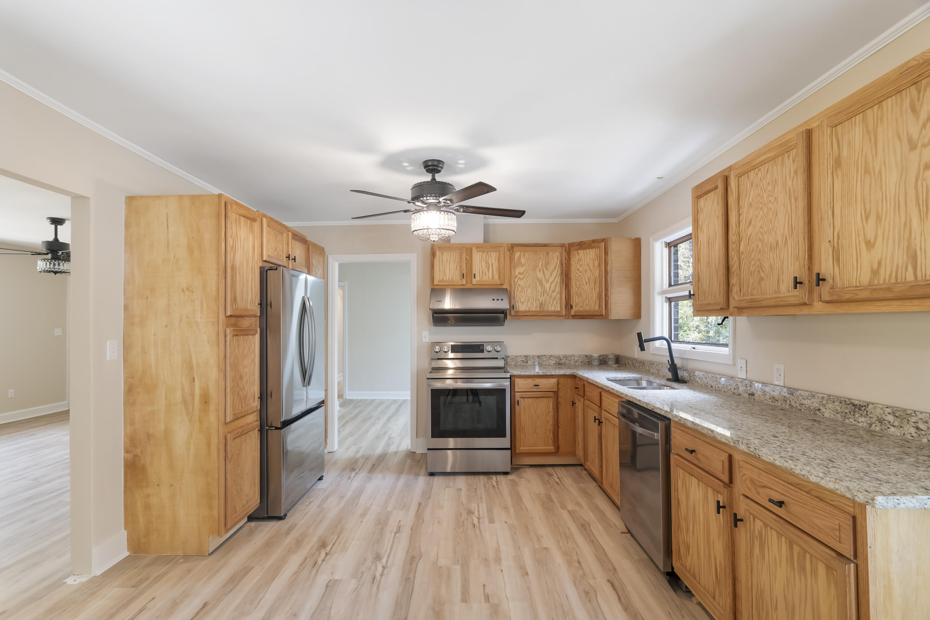 39 Gantt Street Wagener, SC 29164 - Photo 8 of 30 a kitchen with stainless steel appliances granite countertop a refrigerator a sink dishwasher a stove and white countertops with wooden floor