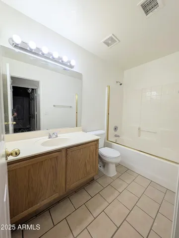 a bathroom with a double vanity sink mirror and toilet