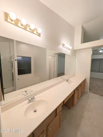 a bathroom with a double vanity sink and mirror