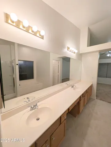 a bathroom with a double vanity sink and mirror