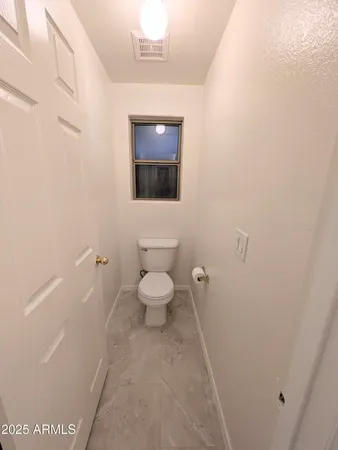 a bathroom with a toilet and a sink