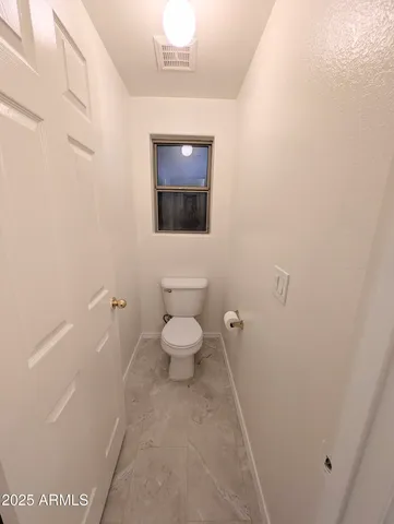a bathroom with a toilet and a sink