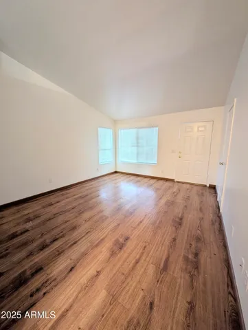 a view of an empty room and wooden floor
