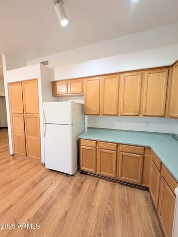 a kitchen with wooden cabinets and a sink