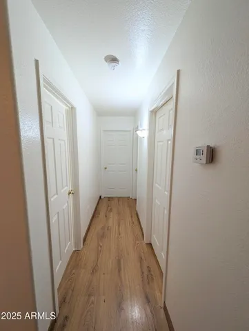 a view of a hallway with wooden floor