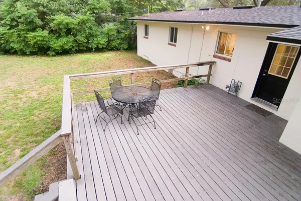 a terrace with outdoor seating and wooden floor