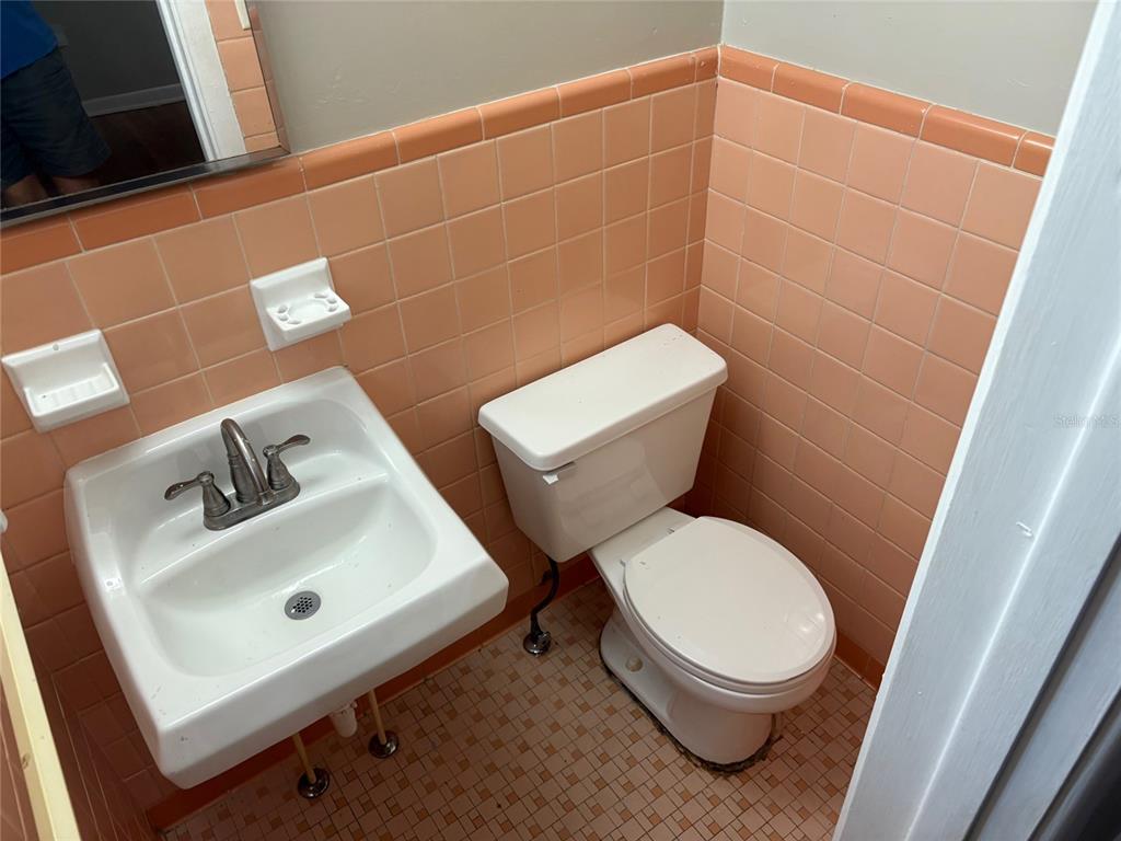 401 Northwest 36th Street Gainesville, FL 32607 - Photo 10 of 13 a white toilet sitting next to a bathroom sink