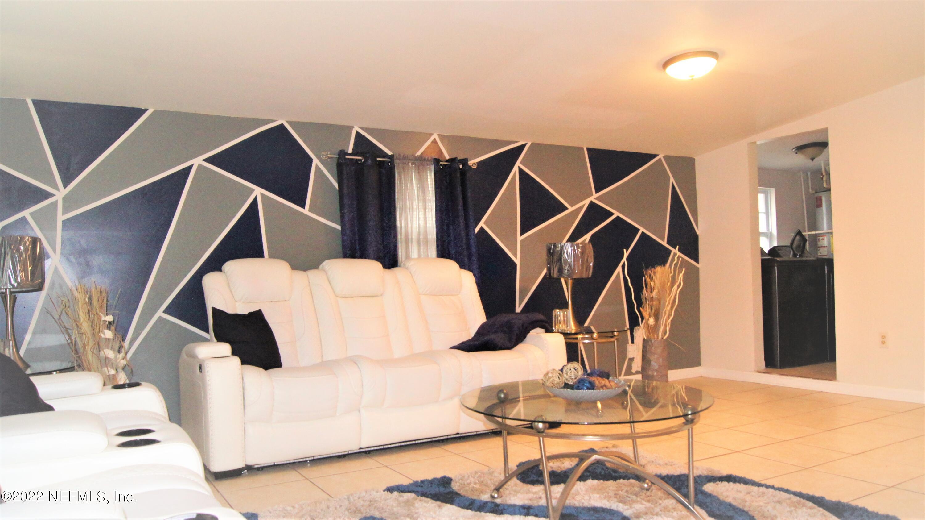7506 Strato Road Jacksonville, FL 32210 - Photo 3 of 10 a utility room with lots of chairs and mirrors