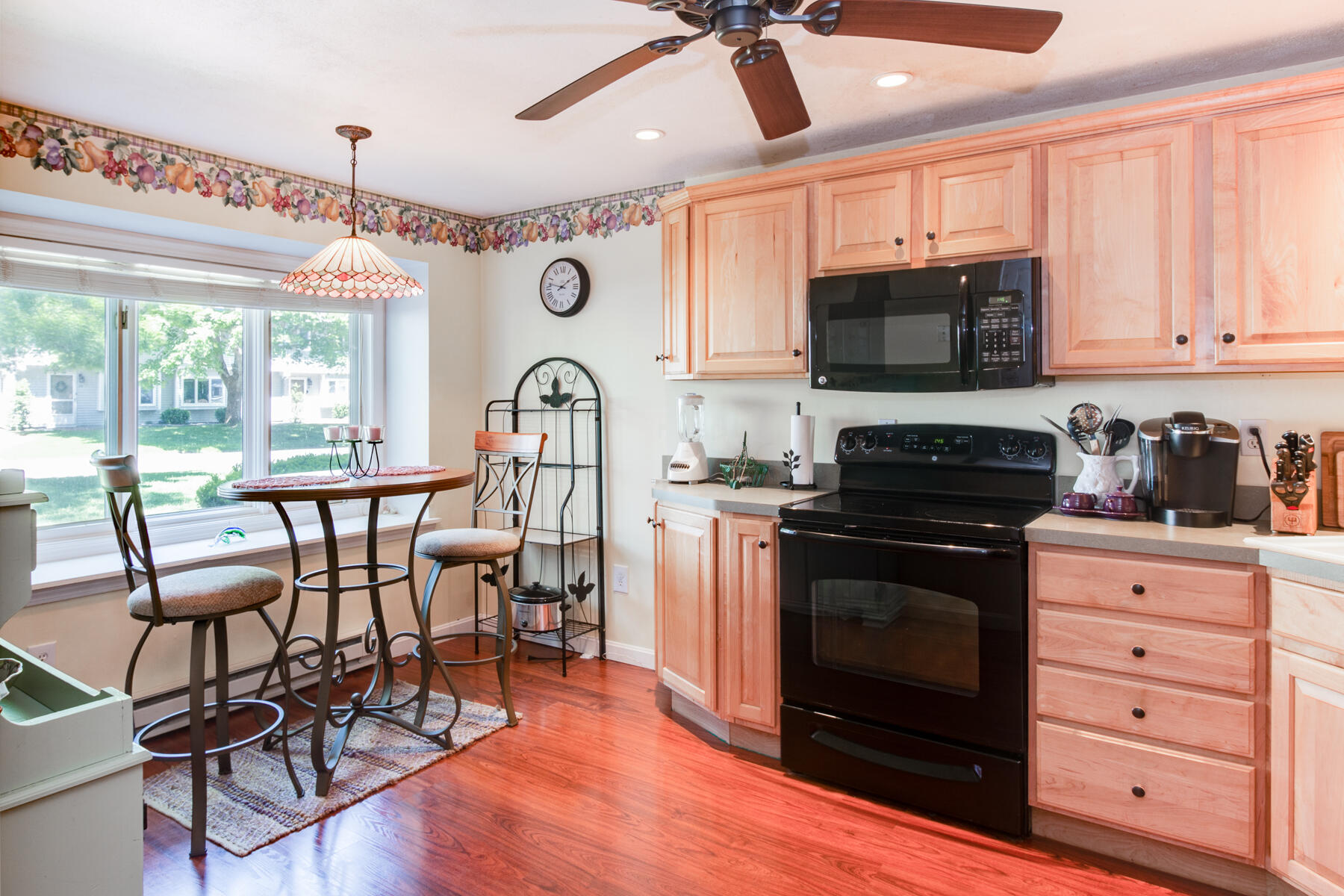 174 Lowell Road, Unit U14 Mashpee, MA 02649 - Photo 13 of 31 a kitchen with stainless steel appliances a stove a sink cabinets and a dining table