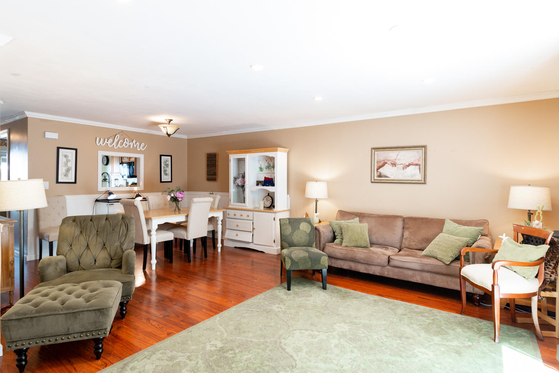 174 Lowell Road, Unit U14 Mashpee, MA 02649 - Photo 20 of 31 a living room with furniture and a dining table with wooden floor