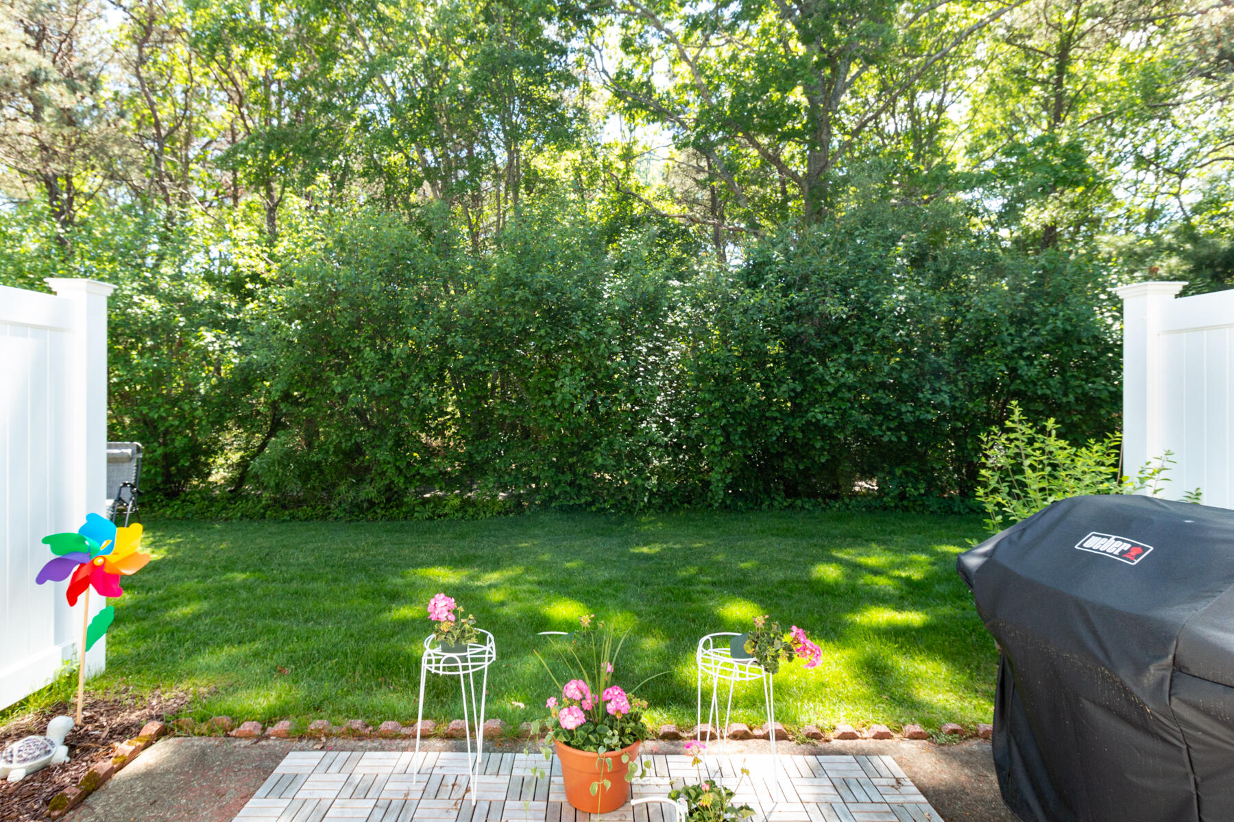 174 Lowell Road, Unit U14 Mashpee, MA 02649 - Photo 7 of 31 a backyard of a house with seating space