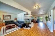 a view of a kitchen with kitchen island granite countertop a sink and a large window
