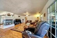 a living room with fireplace furniture and a flat screen tv