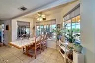 a dining room with furniture and a potted plant