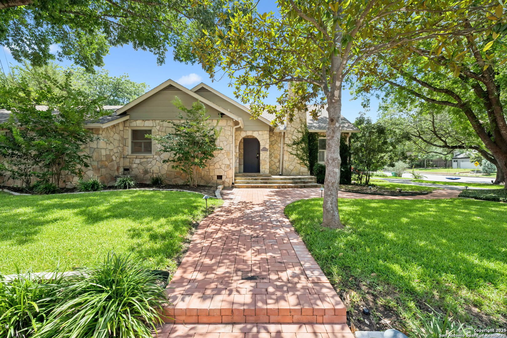 a front view of a house with garden