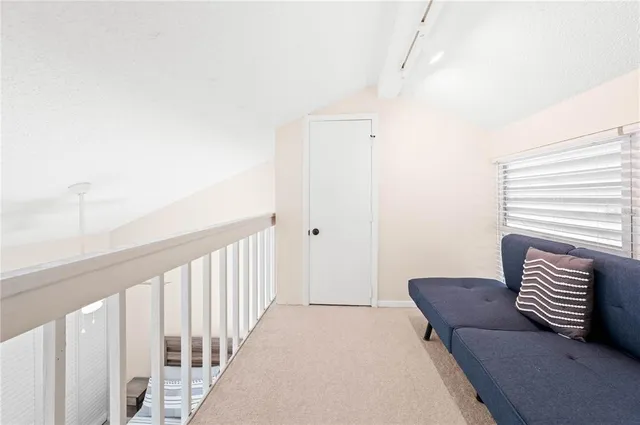 a view of a hallway with couch and a potted plant