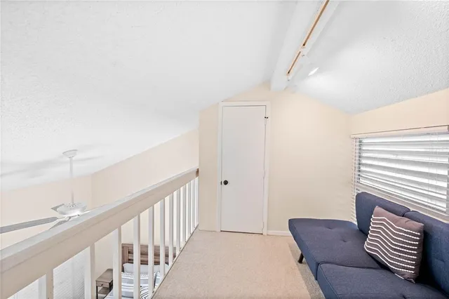 a living room with furniture and a ceiling fan