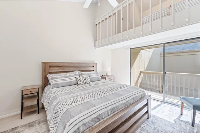 a bedroom with a bed a mirror and a window