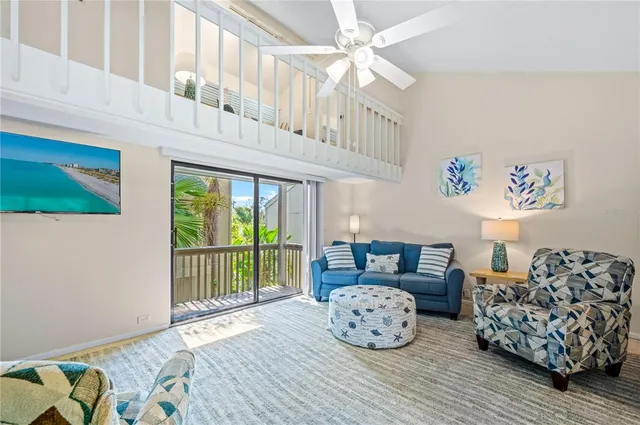 a bedroom with furniture and a large window