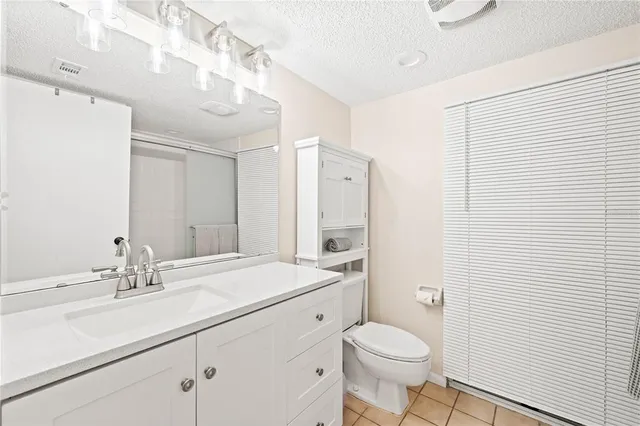 a bathroom with a sink a toilet a mirror and vanity