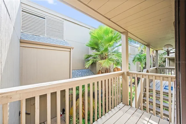 a view of a balcony with wooden floor