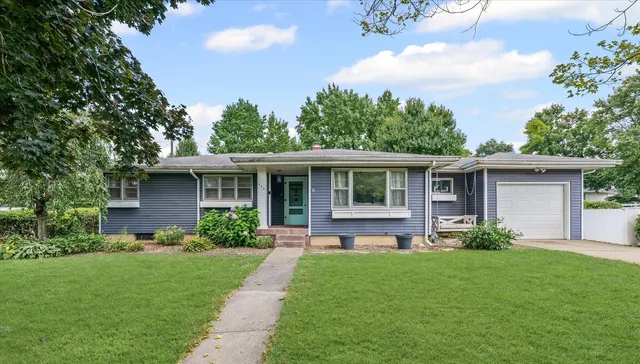 a front view of house with a garden and patio
