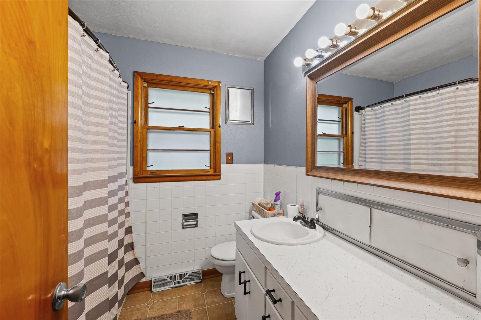 449 South Irving Street Monticello, IL 61856 - Photo 15 of 33 a bathroom with a sink a toilet and mirror