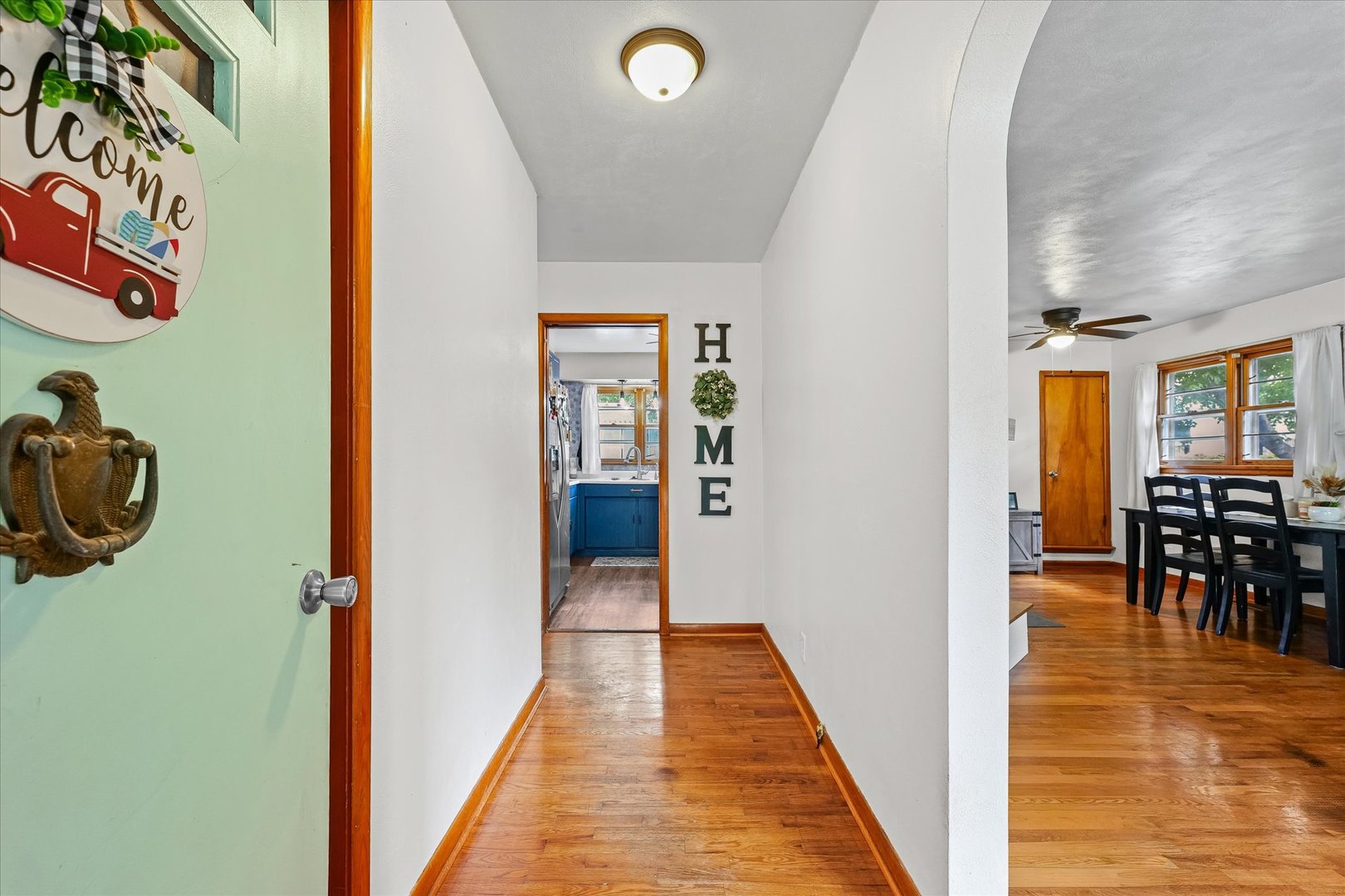 449 South Irving Street Monticello, IL 61856 - Photo 4 of 33 a view of a hallway with dining room and wooden floor