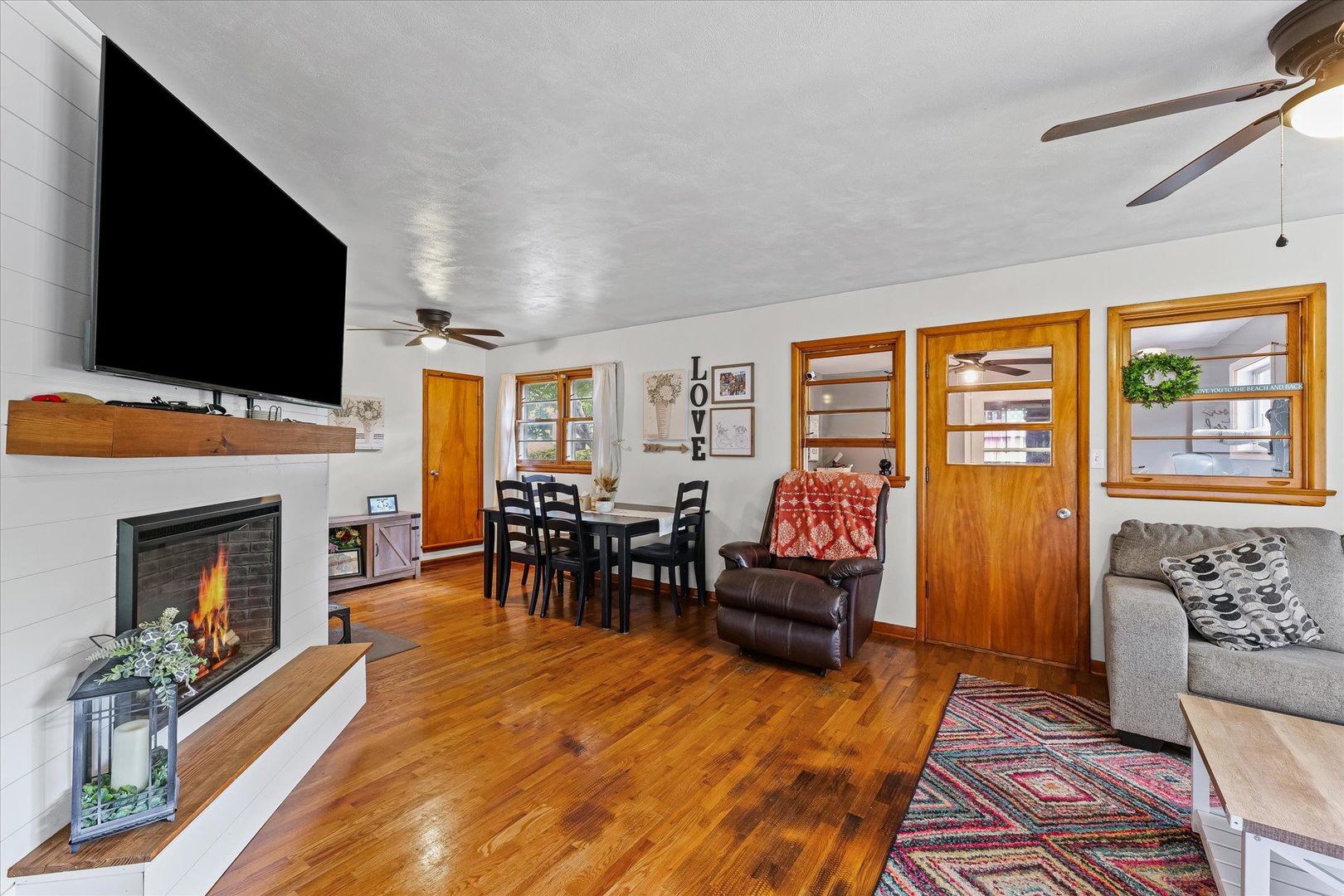 449 South Irving Street Monticello, IL 61856 - Photo 5 of 33 a living room with furniture a flat screen tv and a fireplace