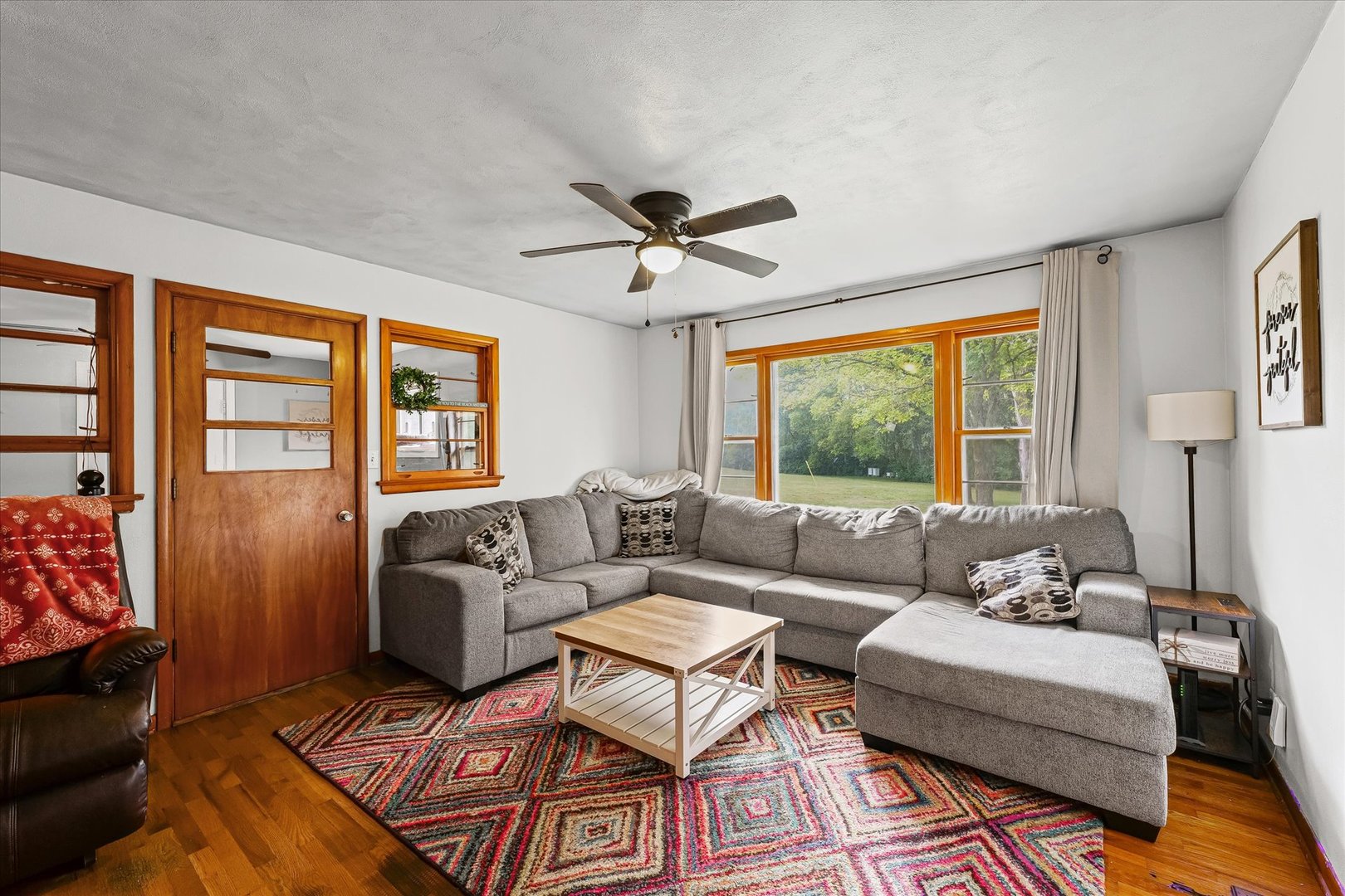 449 South Irving Street Monticello, IL 61856 - Photo 8 of 33 a living room with furniture a flat screen tv and a large window