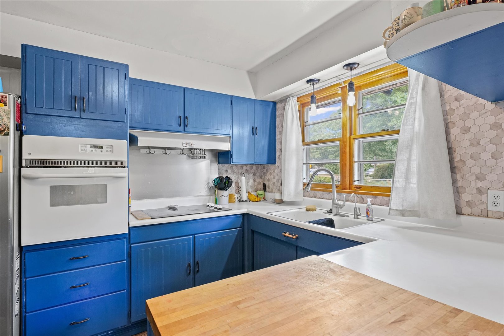 449 South Irving Street Monticello, IL 61856 - Photo 10 of 33 a kitchen with wooden cabinets and white appliances