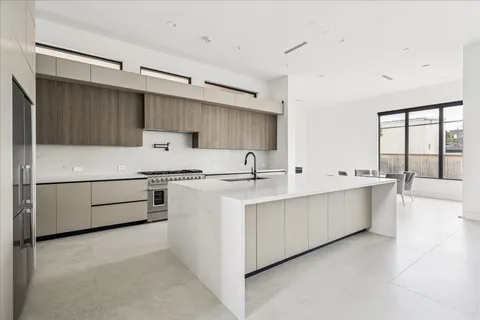 a kitchen with cabinets a sink and white stainless steel appliances