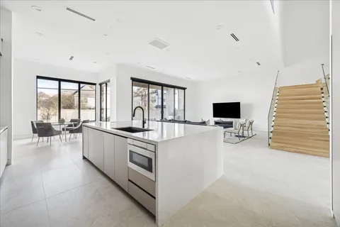 a large white room with a large window and a flat screen tv