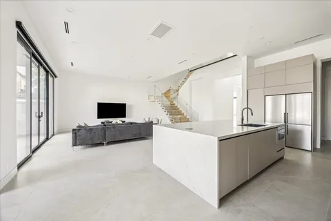 a large white room with a large window and a couch