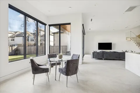 a living room with furniture tv and a large window