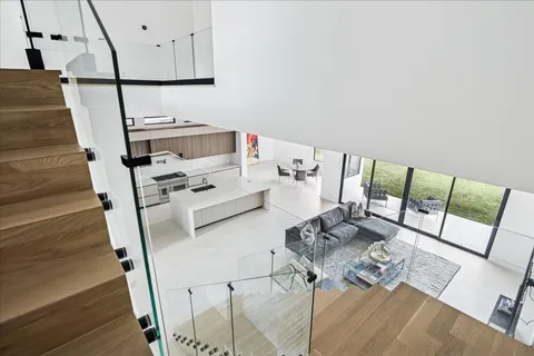 a living room with furniture and a floor to ceiling window