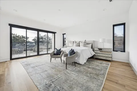 a spacious bedroom with a bed and a large window