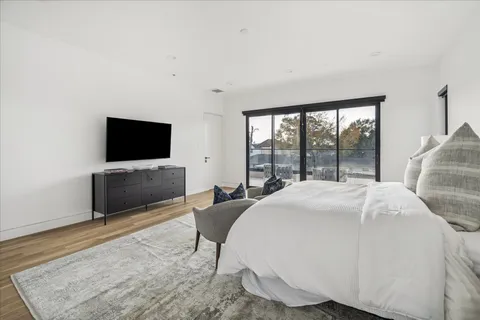 a bedroom with a bed and a flat screen tv