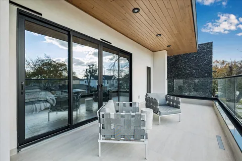 a dining room with furniture and a floor to ceiling window