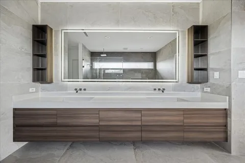 a view of bathroom with sink and mirror