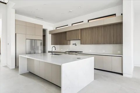 a kitchen with stainless steel appliances a sink stove and cabinets