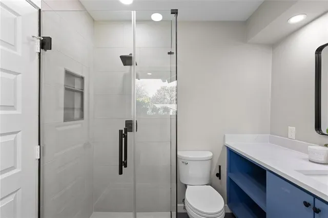 a bathroom with a granite countertop toilet sink and shower