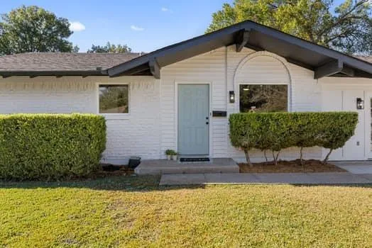 a front view of a house with garden