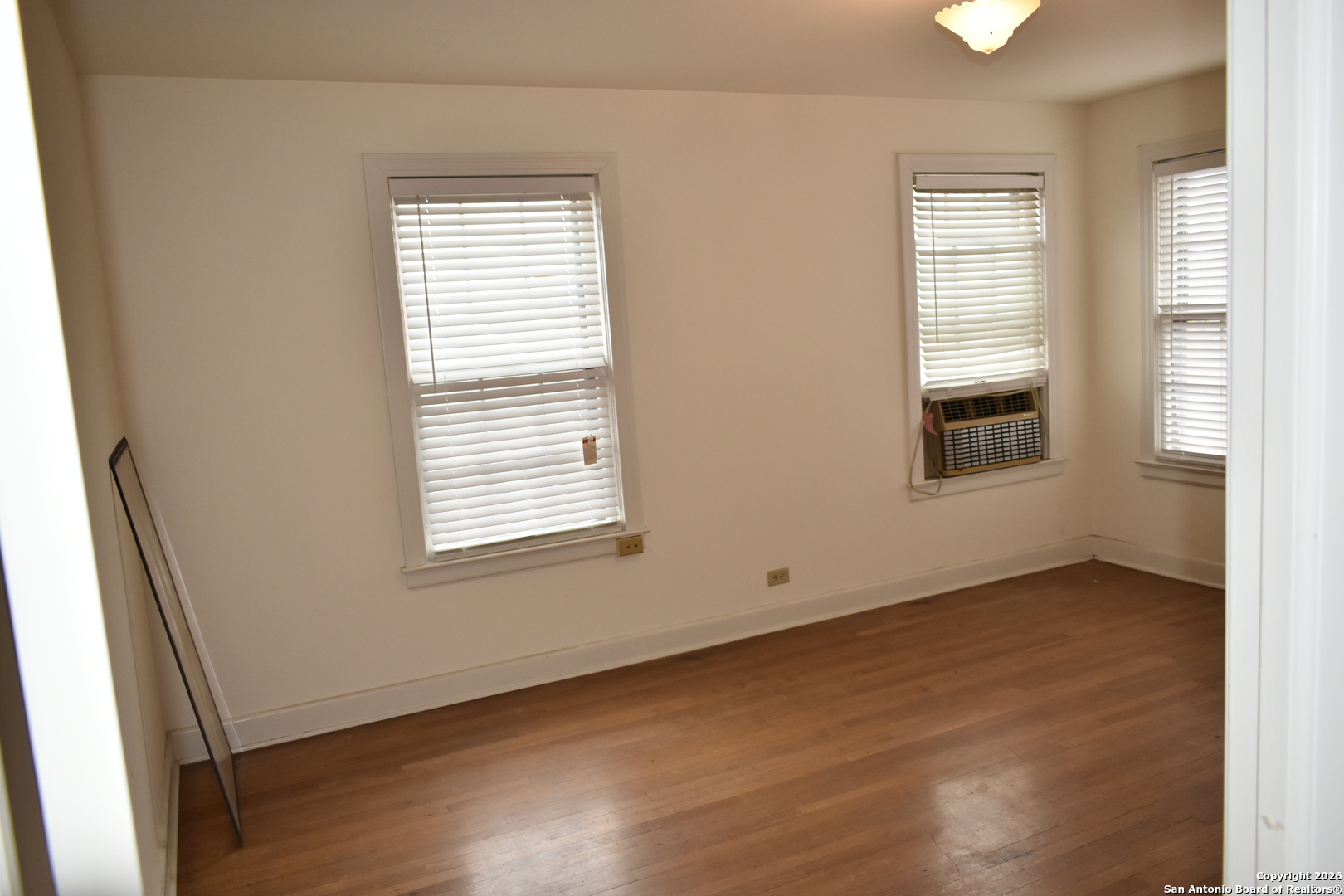 320 Babcock Road San Antonio, TX 78201 - Photo 15 of 27 an empty room with wooden floor and windows