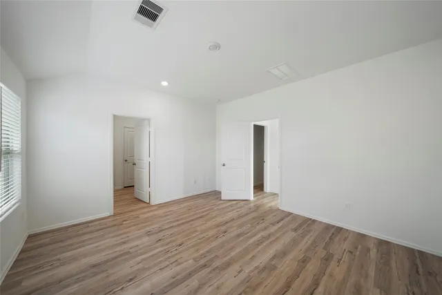a spacious bathroom with a double vanity sink and a mirror