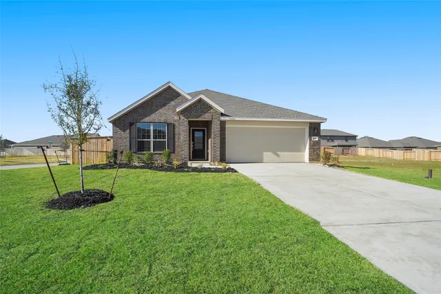 a view of a house with a big yard and potted plants