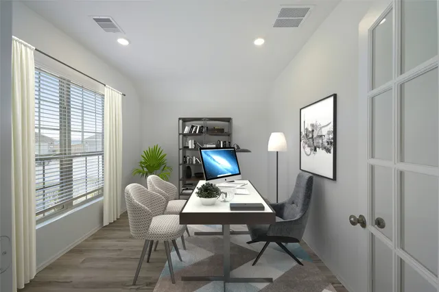 a view of a workspace with furniture and a window