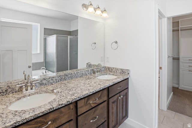 3636 West 910 South Syracuse, UT 84075 - Photo 8 of 70 Double vanity featuring undermount sinks and a speckled stone countertop