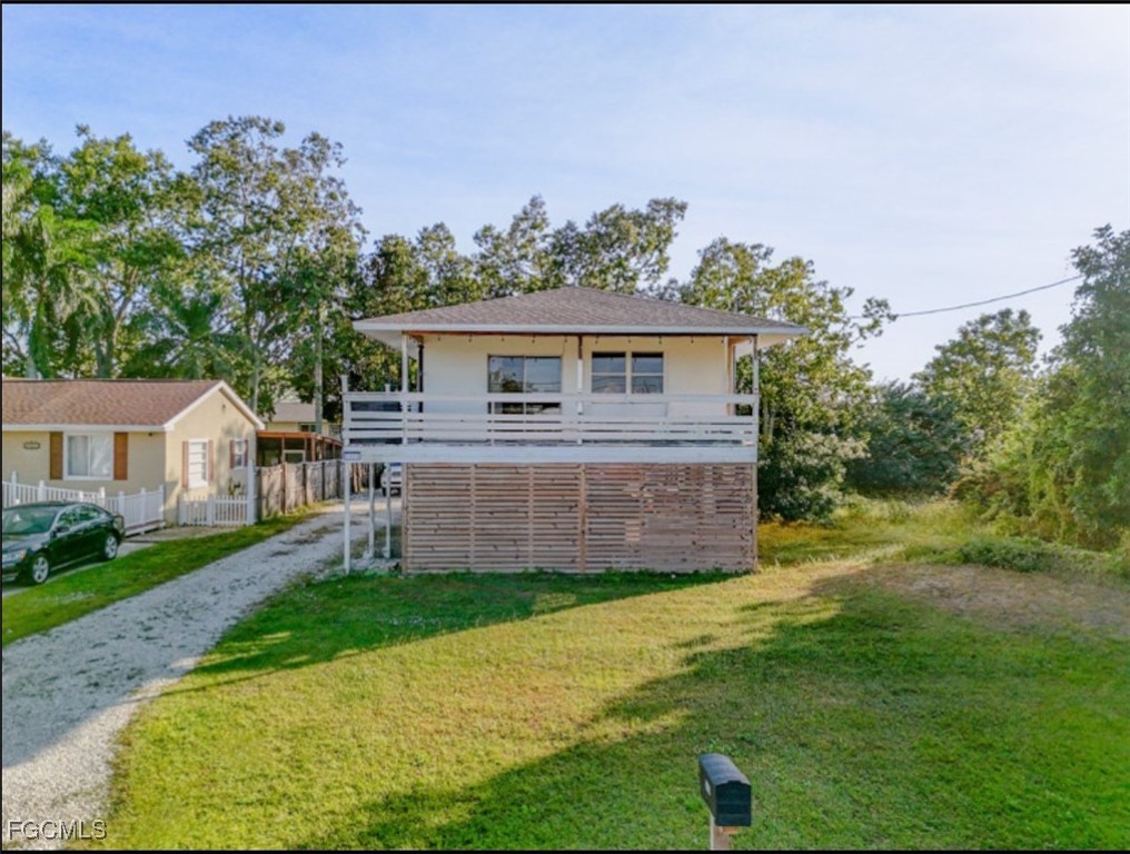 a view of a house with a yard and a garden