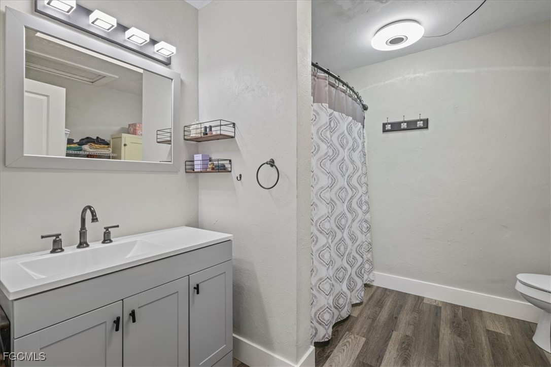 3909 3rd Street Southwest Lehigh Acres, FL 33976 - Photo 12 of 16 a bathroom with a sink a toilet and shower